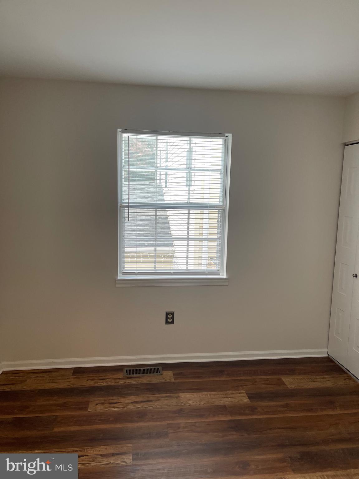 2313 Westport Lane Crofton, MD 21114 - Photo 16 of 34 a view of an empty room with wooden floor and a window