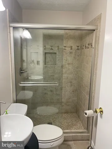 a bathroom with a toilet and a shower