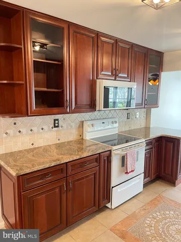 a kitchen with stainless steel appliances granite countertop a sink and a stove
