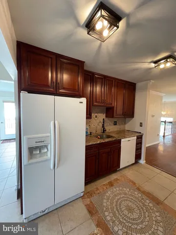 a kitchen with a refrigerator and a sink
