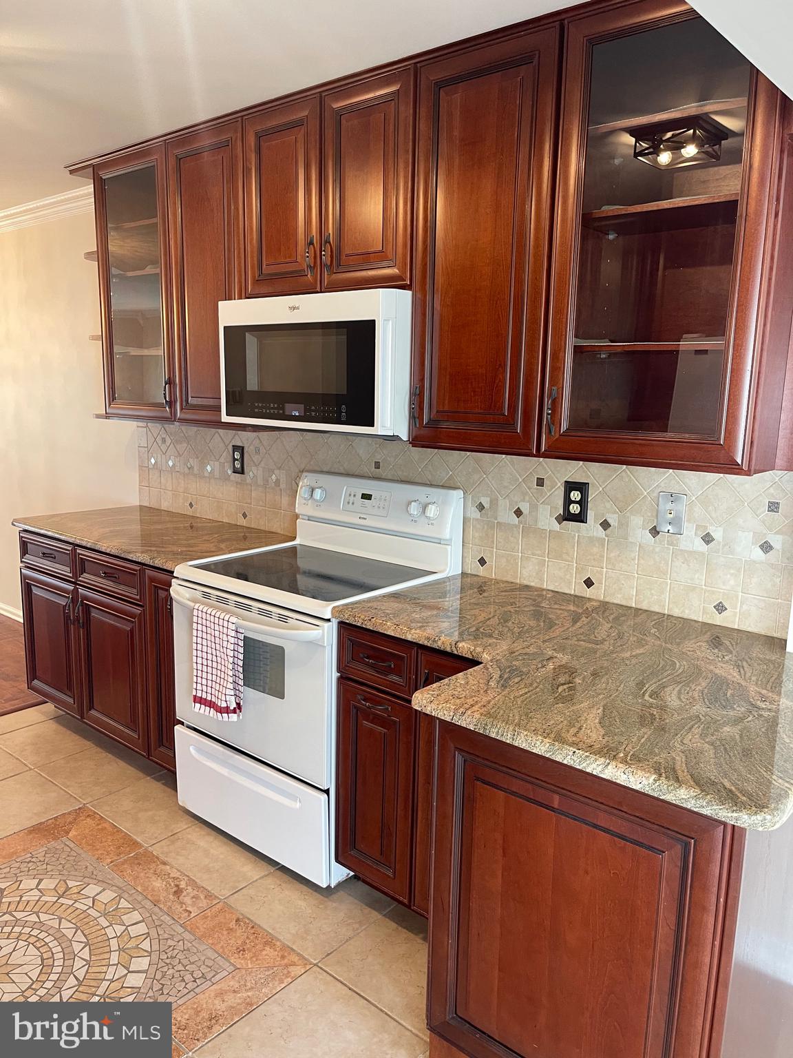 2313 Westport Lane Crofton, MD 21114 - Photo 7 of 34 a kitchen with granite countertop wooden cabinets and stainless steel appliances