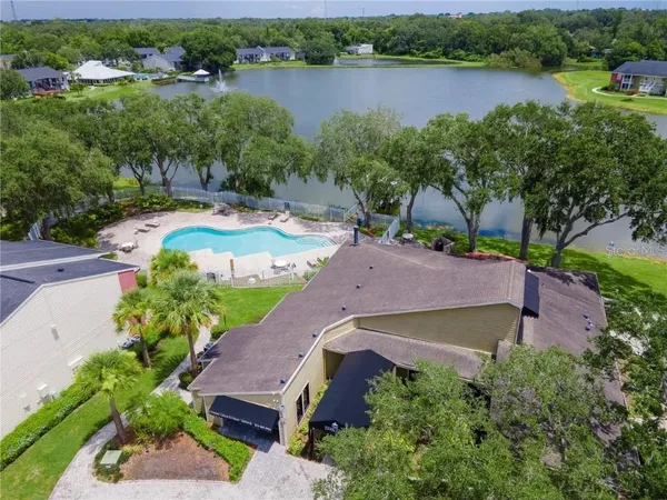 an aerial view of a house with outdoor space and lake view