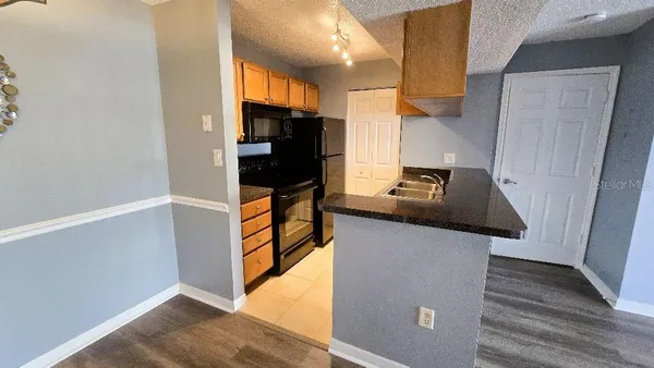 a kitchen with stainless steel appliances granite countertop a refrigerator and a stove top oven