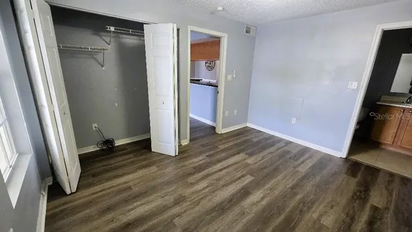a view of a room with wooden floor and a window