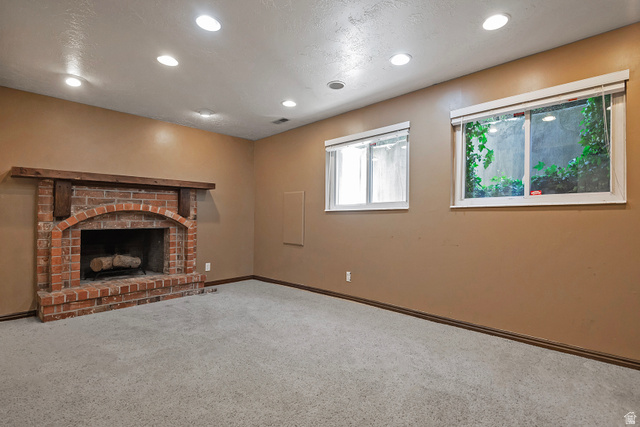 3310 Creek Road Salt Lake City, UT 84121 - Photo 33 of 49 Brick fireplace with a substantial wood mantel