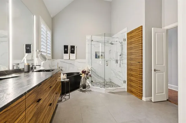 a spacious bathroom with a granite countertop sink a toilet and shower