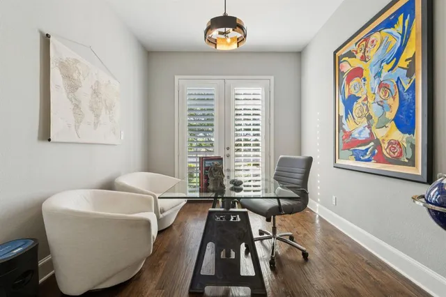 a view of a workspace with furniture and a window