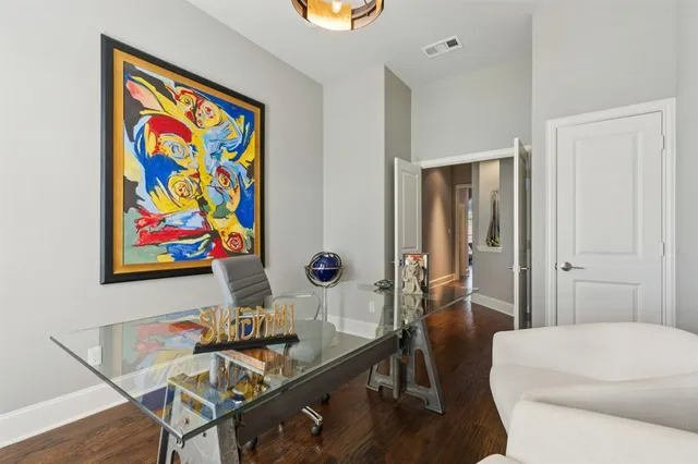 a living room with furniture and wall paintings