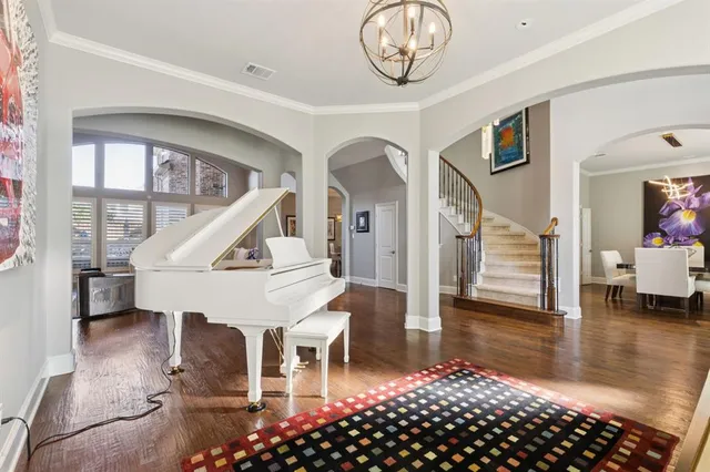 a view of entryway and hall with wooden floor