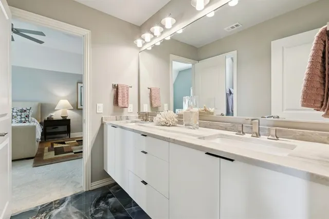 a bathroom with a double vanity sink and a mirror