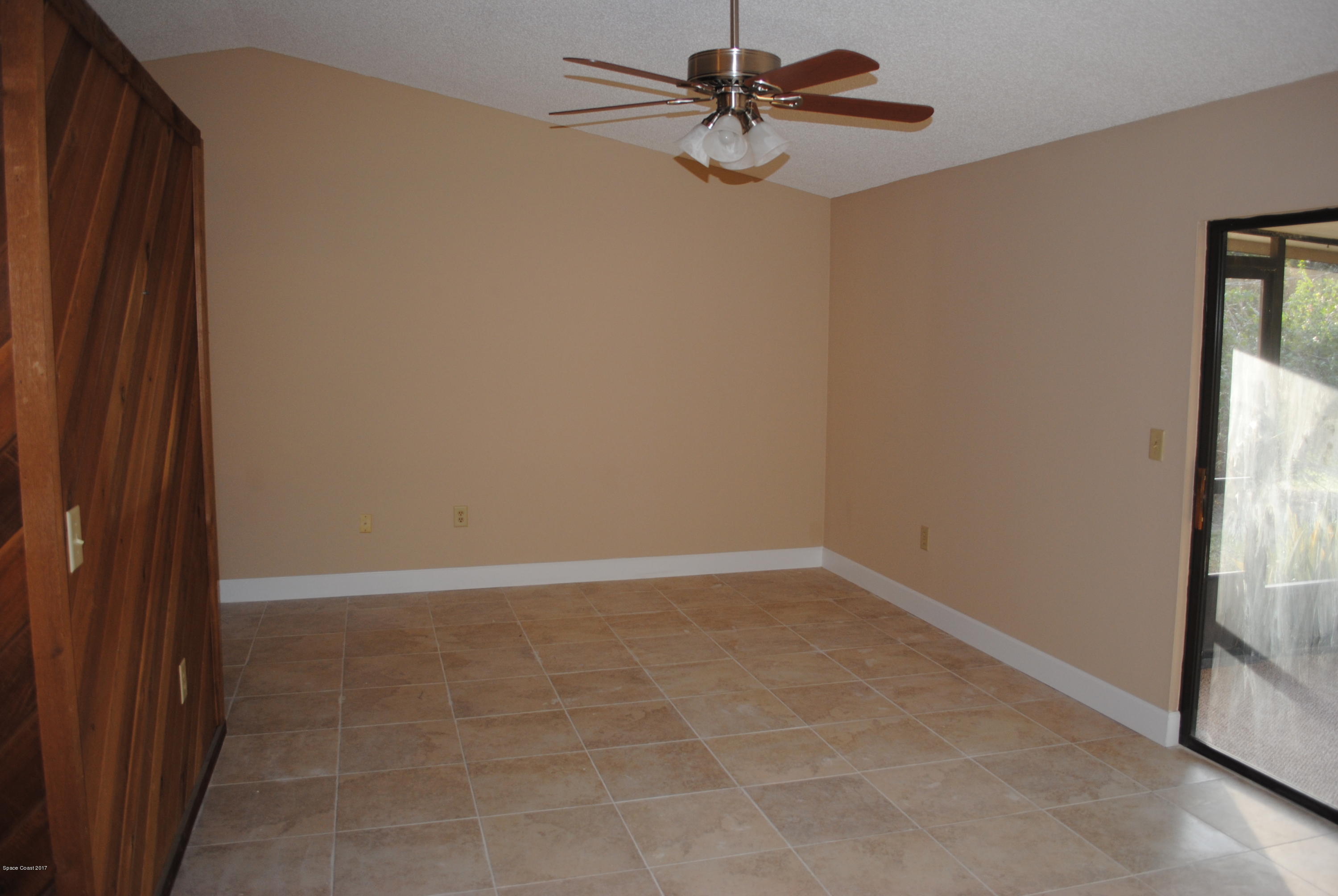 1312 Whitehurst Road Southwest Palm Bay, FL 32908 - Photo 14 of 35 a view of a small space with wooden floor and a chandelier fan
