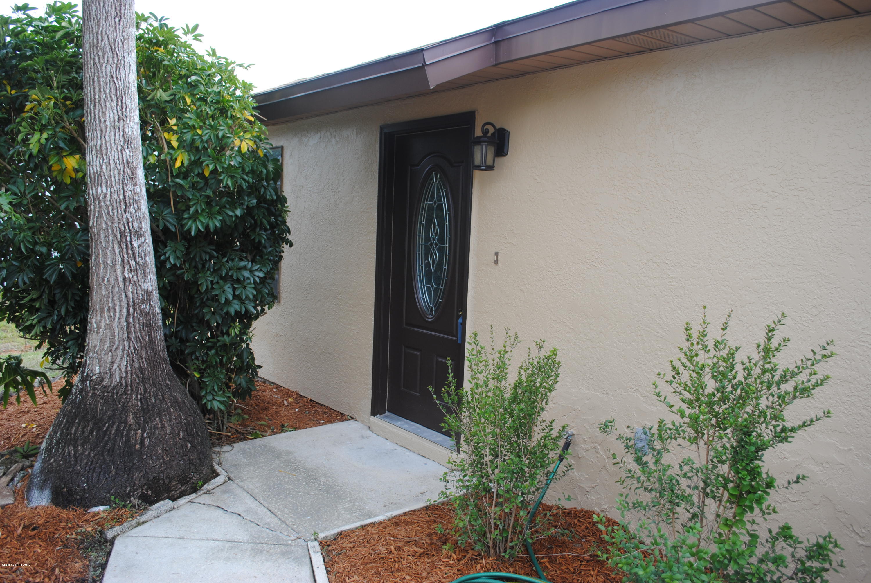 1312 Whitehurst Road Southwest Palm Bay, FL 32908 - Photo 3 of 35 a view of a house with a backyard