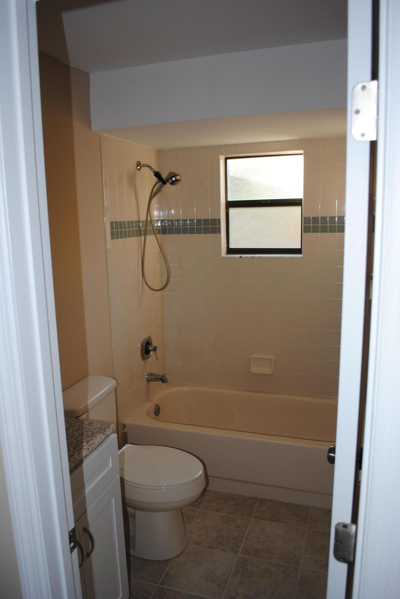 1312 Whitehurst Road Southwest Palm Bay, FL 32908 - Photo 23 of 35 a bathroom with a granite countertop toilet and a shower