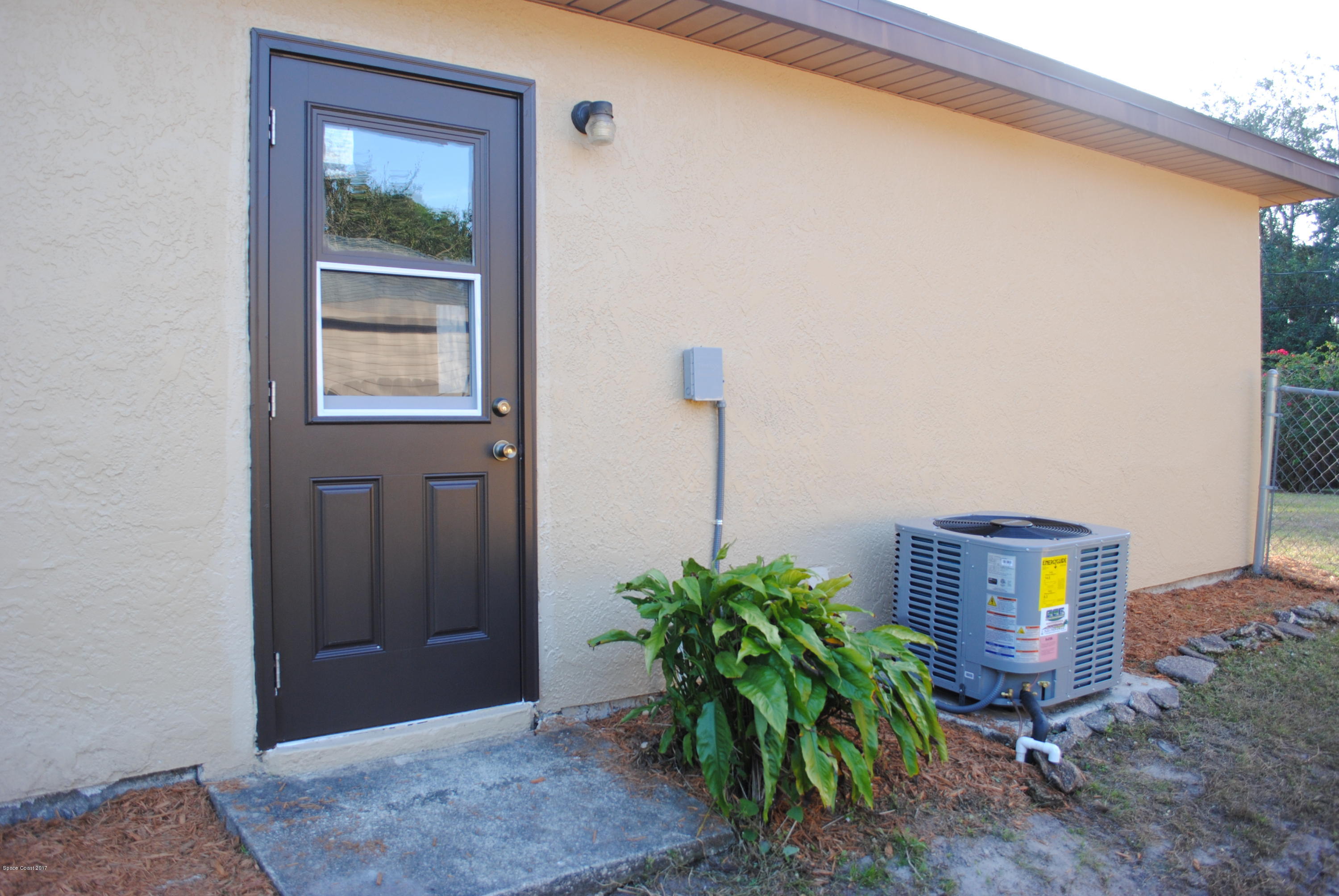 1312 Whitehurst Road Southwest Palm Bay, FL 32908 - Photo 33 of 35 a room with a potted plant