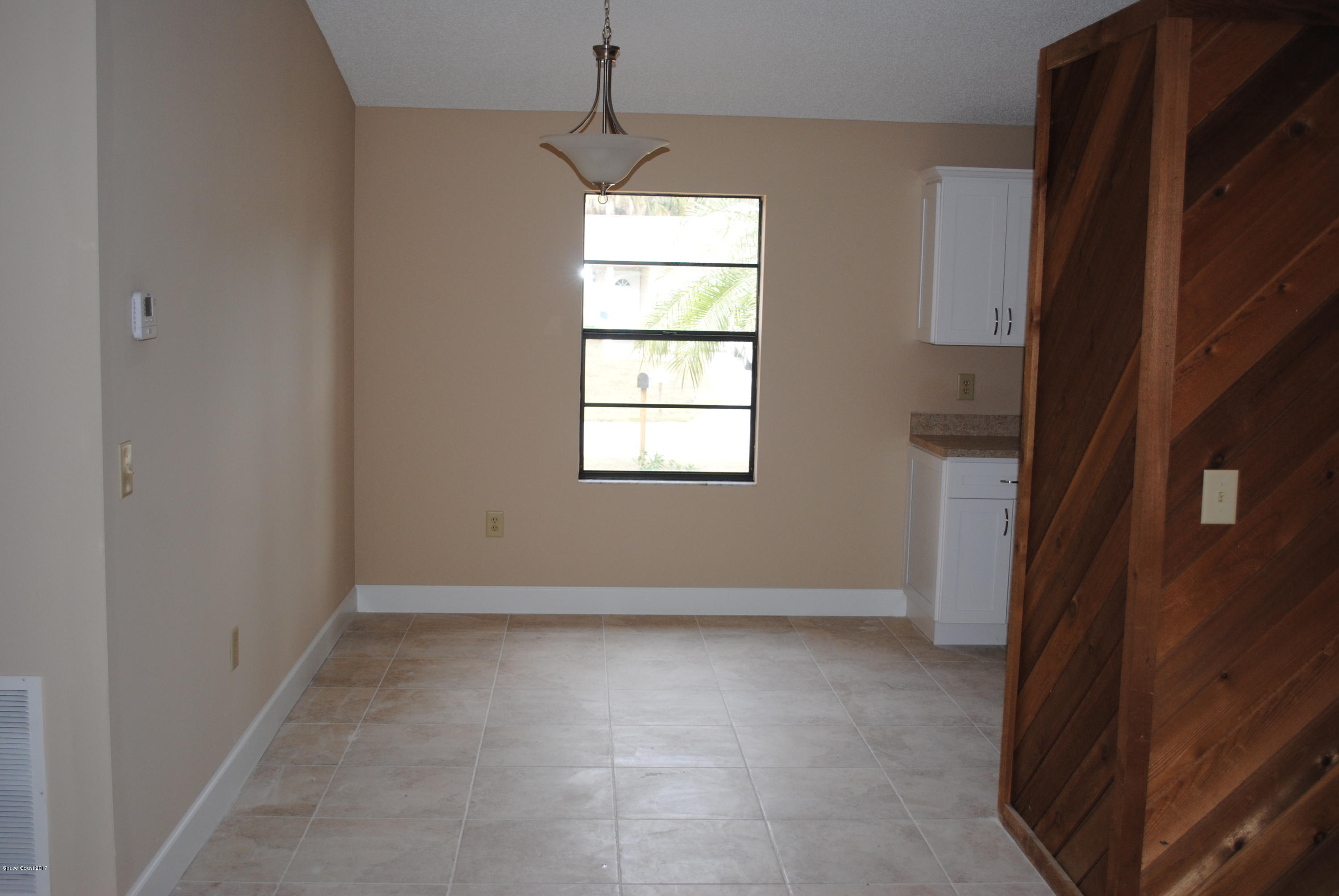 1312 Whitehurst Road Southwest Palm Bay, FL 32908 - Photo 7 of 35 an empty room with windows