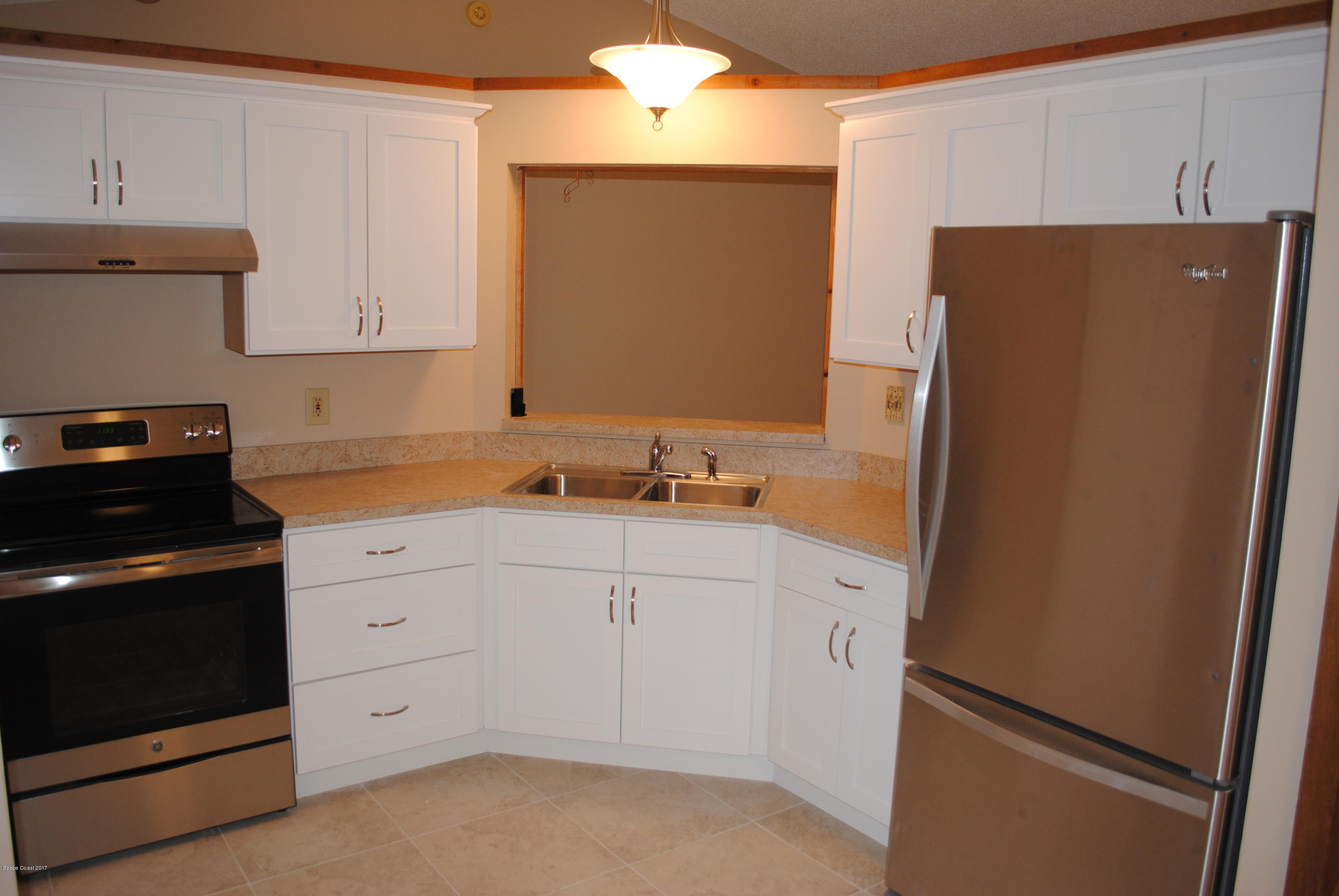 1312 Whitehurst Road Southwest Palm Bay, FL 32908 - Photo 8 of 35 a kitchen with a refrigerator sink and cabinets