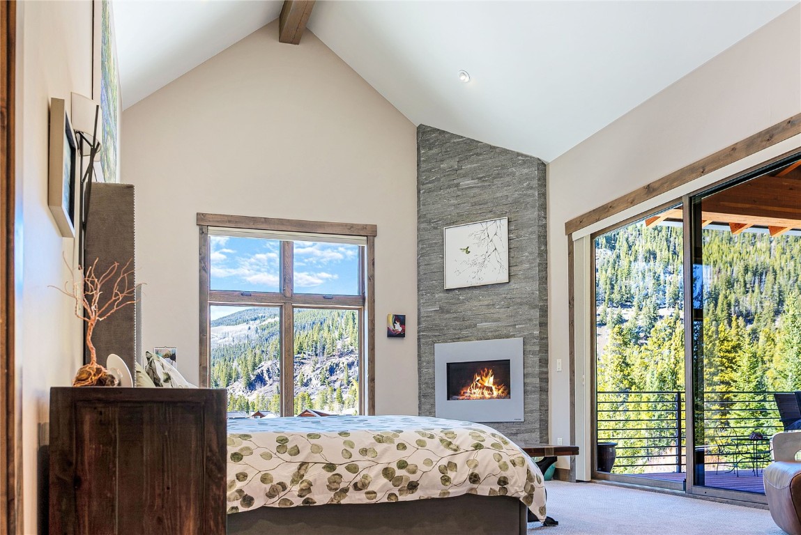 11 West Independence Road Keystone, CO 80435 - Photo 11 of 50 a bedroom with a large bed and a fireplace