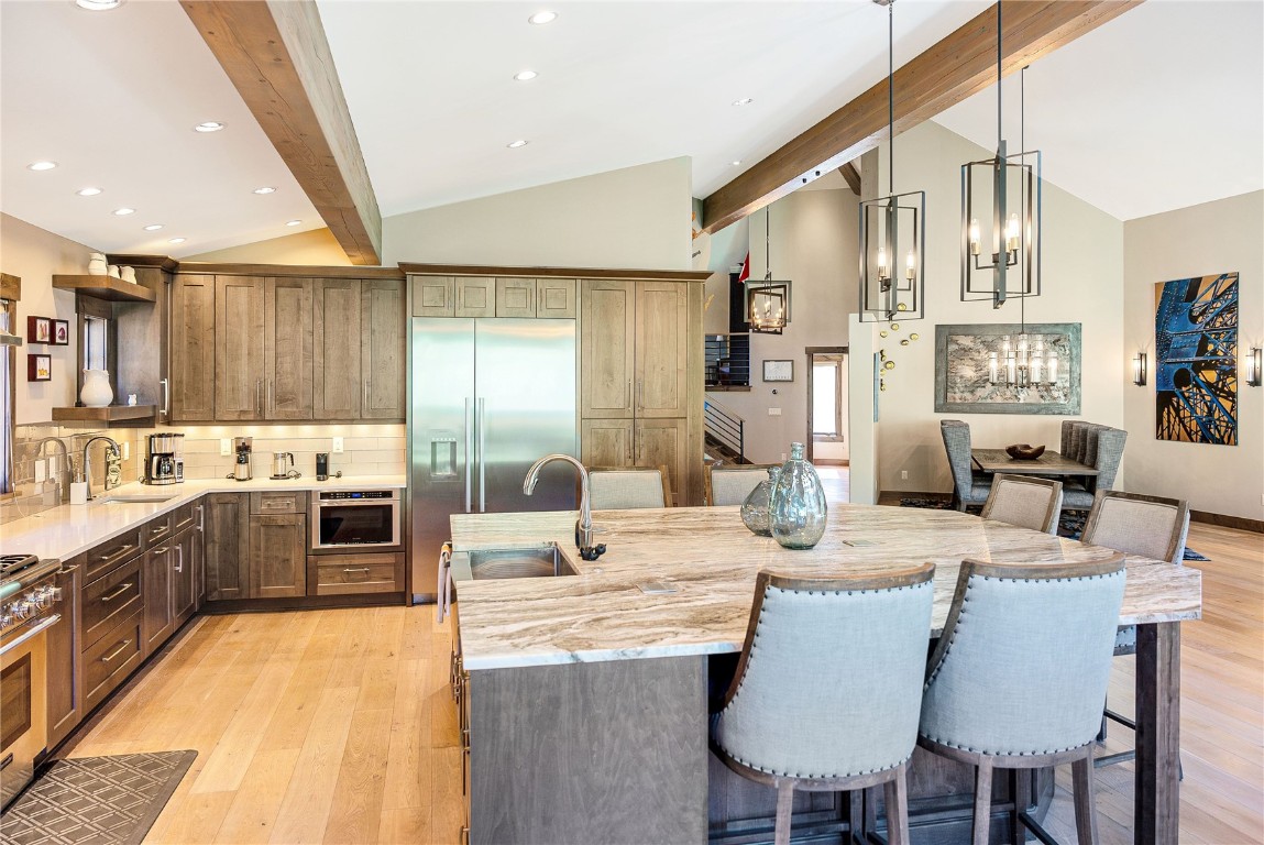 11 West Independence Road Keystone, CO 80435 - Photo 22 of 50 a large kitchen with stainless steel appliances kitchen island granite countertop a sink and cabinets