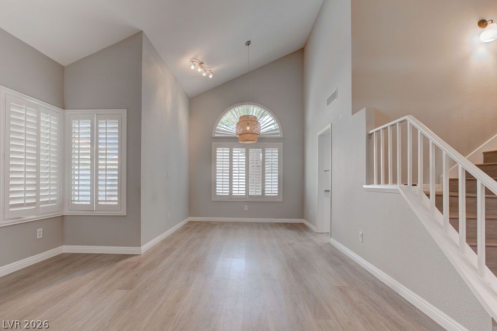 1416 Walstone Road North Las Vegas, NV 89031 - Photo 4 of 47 Step into this spacious living area, showcasing soaring vaulted ceilings and elegant plantation shutters.
