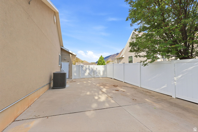 1816 River Bottom Road Springville, UT 84663 - Photo 33 of 37 Expansive concrete patio area featuring a white privacy fence and a gated entry