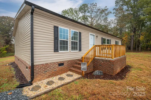 a view of a house with a yard and sitting area