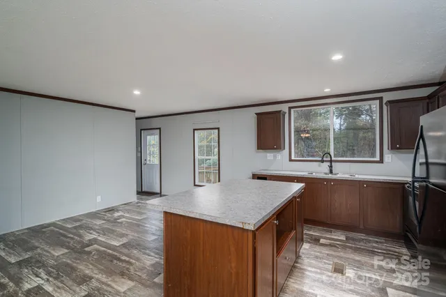 a kitchen with stainless steel appliances granite countertop a stove a refrigerator and a sink