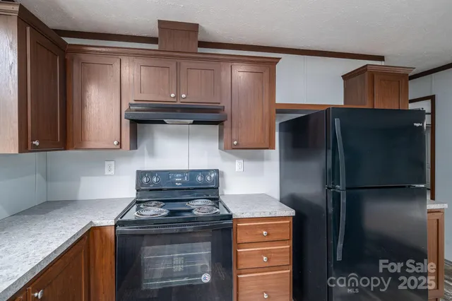 a kitchen with granite countertop a sink and a window