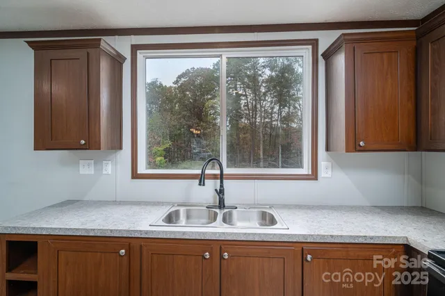 a kitchen with stainless steel appliances kitchen island granite countertop a refrigerator sink and cabinets