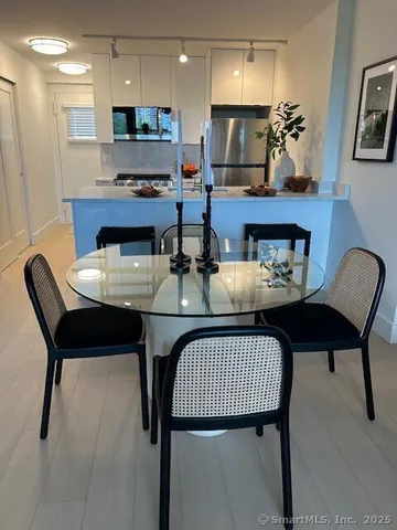 a kitchen with a dining table and chairs