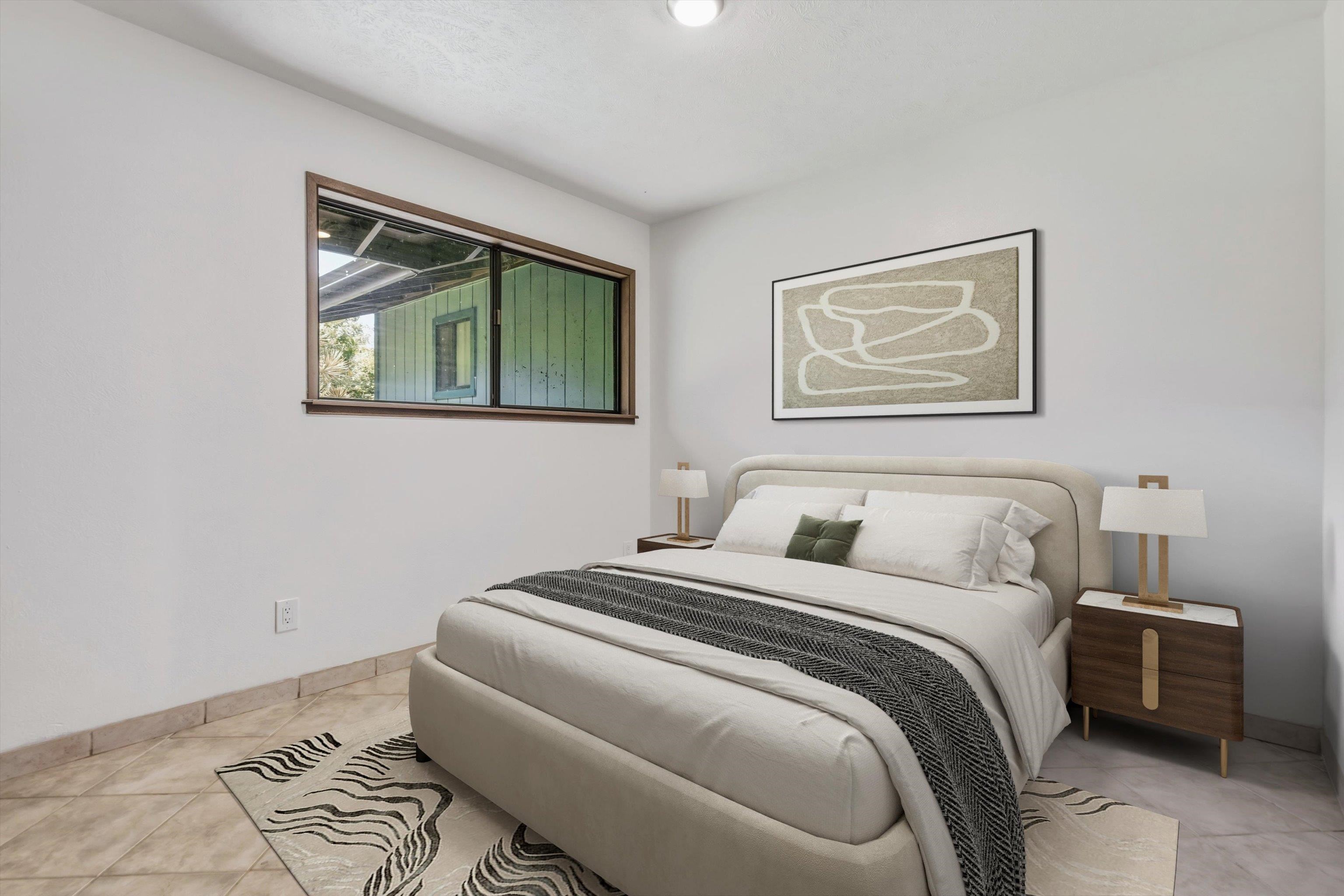 145 South Holokai Road Haiku, HI 96708 - Photo 26 of 50 a bedroom with a bed and a painting on the wall