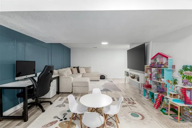 a living room with furniture a rug and a flat screen tv
