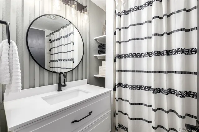 a bathroom with a sink and a mirror