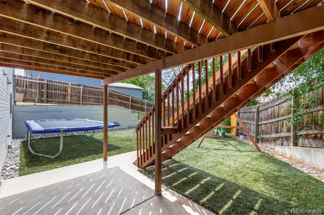 a view of backyard with wooden stairs and a floor to ceiling window