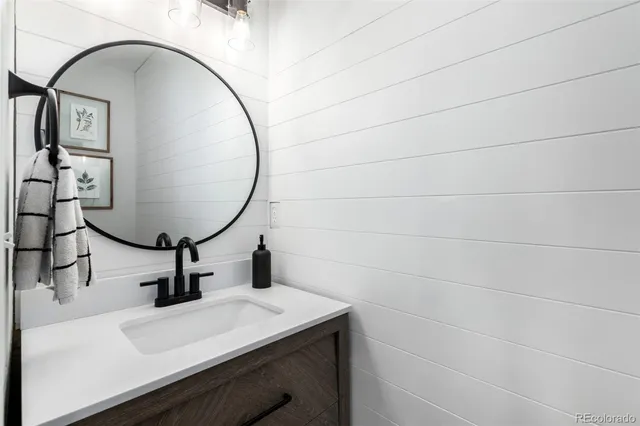 a bathroom with a sink mirror and vanity