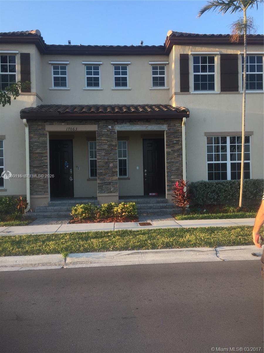 17059 Southwest 96th Street Miami, FL 33196 - Photo 1 of 22 a view of a house with a garden and plants