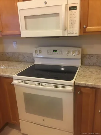 a stove top oven sitting inside of a kitchen