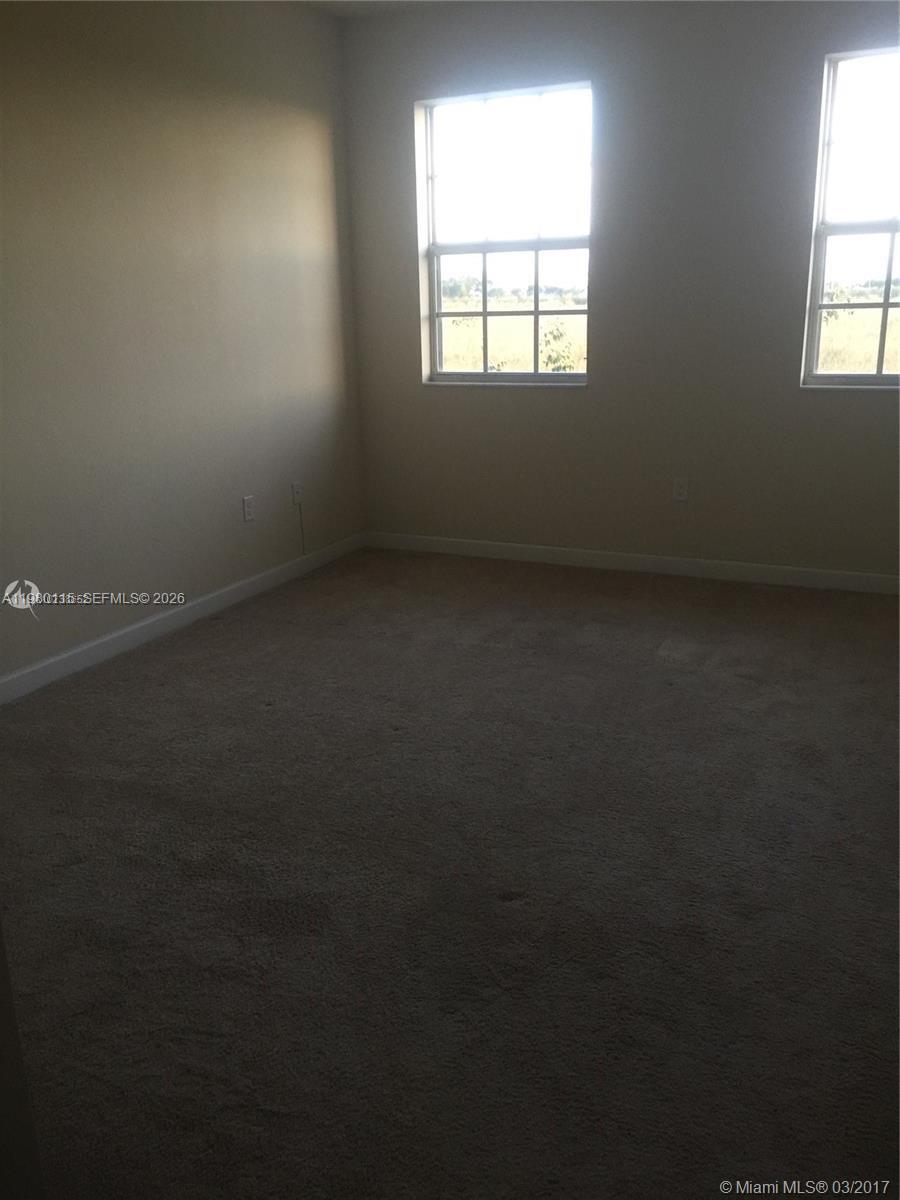 17059 Southwest 96th Street Miami, FL 33196 - Photo 14 of 22 an empty room with a window