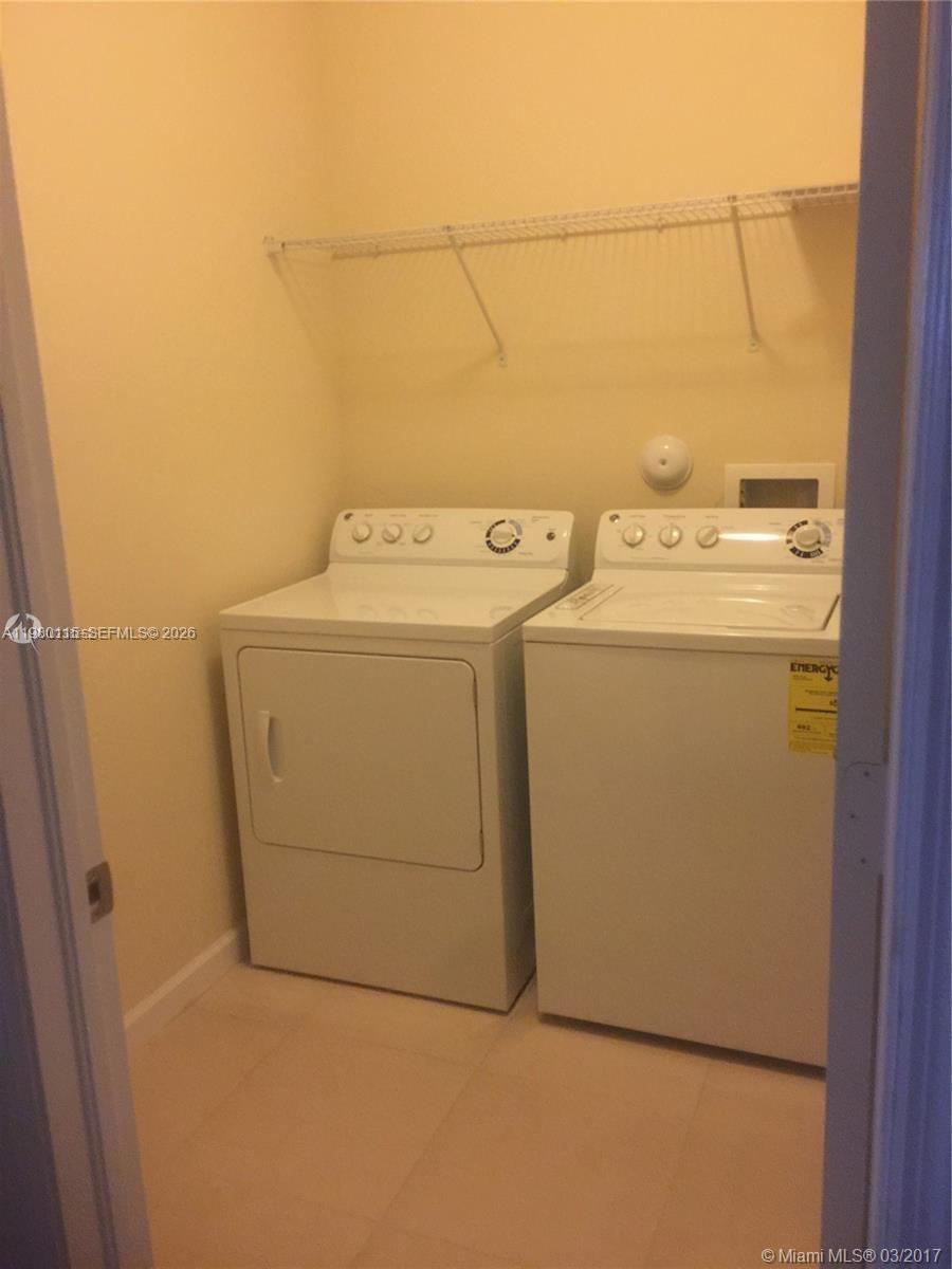 17059 Southwest 96th Street Miami, FL 33196 - Photo 19 of 22 a utility room with dryer and washer