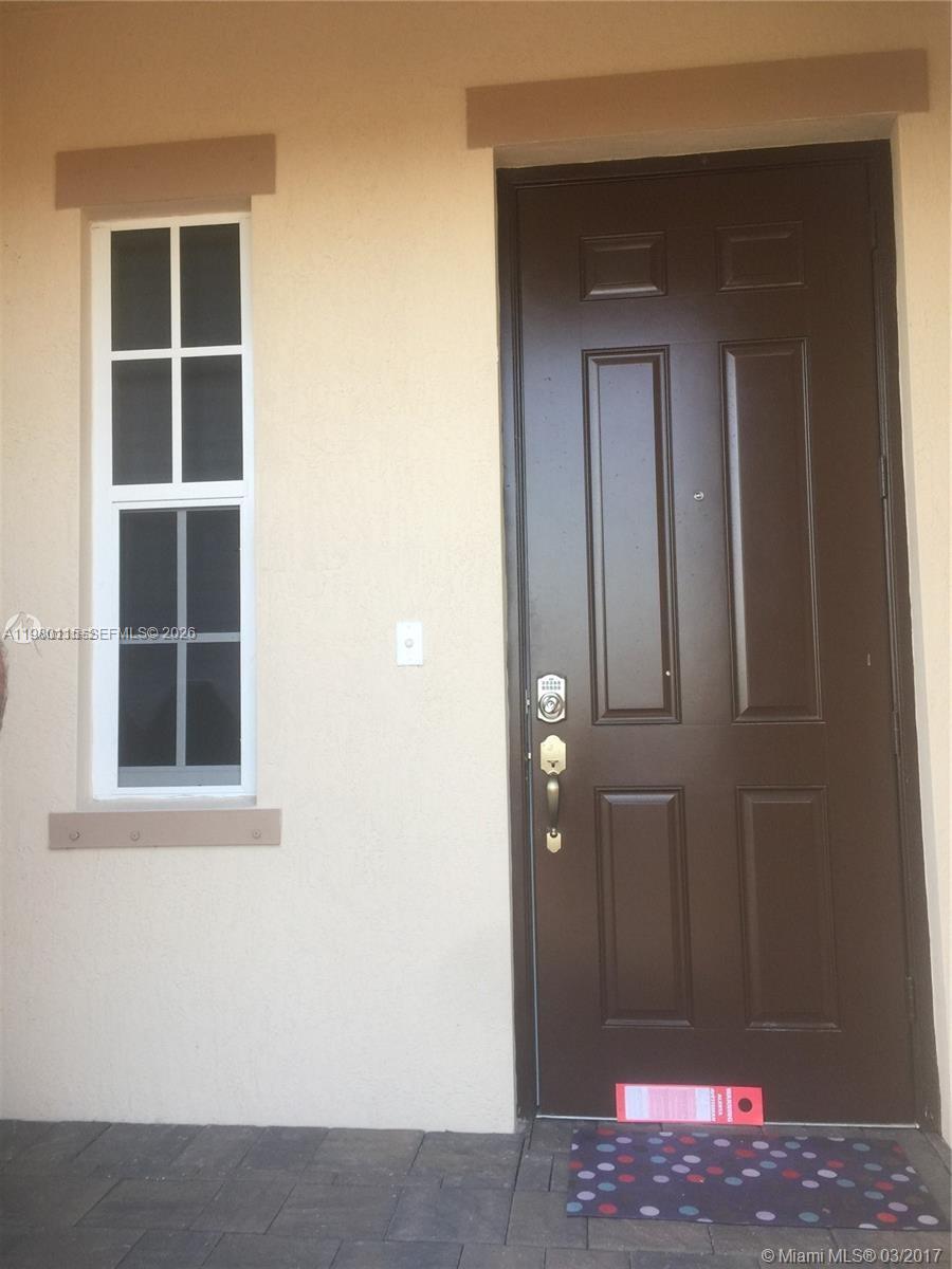 17059 Southwest 96th Street Miami, FL 33196 - Photo 2 of 22 a view of front door of a house