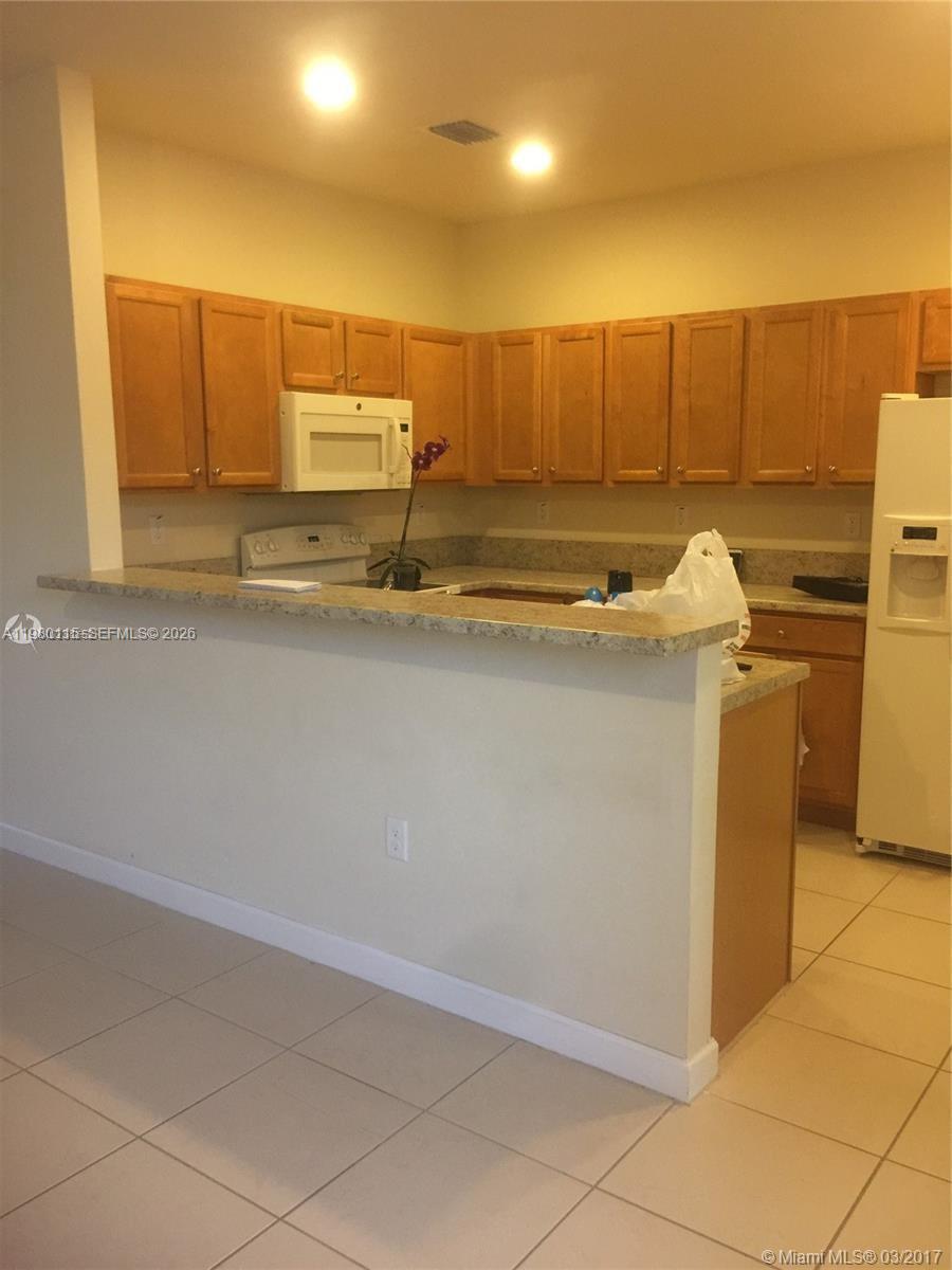 17059 Southwest 96th Street Miami, FL 33196 - Photo 6 of 22 a bathroom with a sink a toilet and mirror