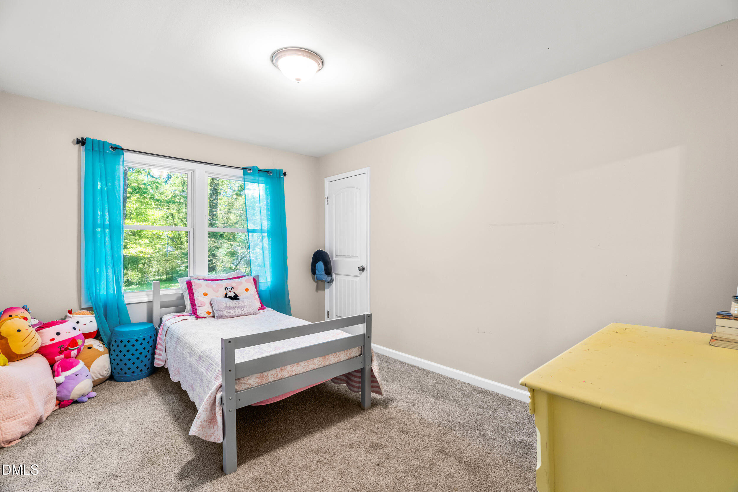 3724 Randell Road Garner, NC 27529 - Photo 21 of 32 a living room with furniture and a baby crib
