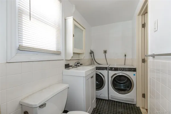 a bathroom with a washing machine and a washer dryer