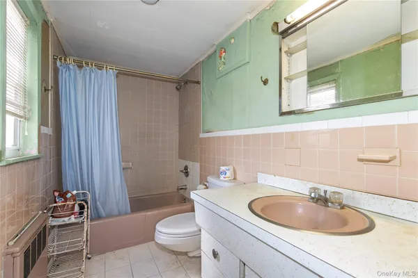 a bathroom with a sink a toilet and bathtub