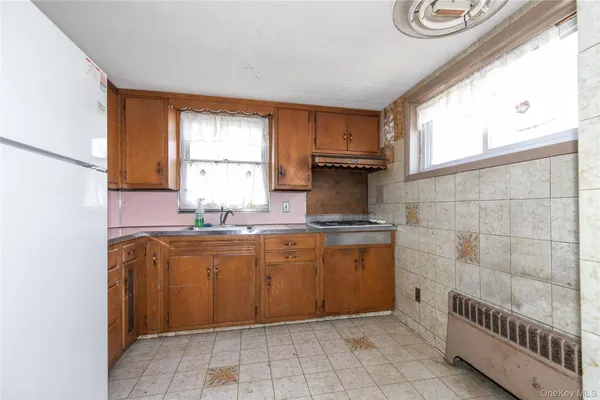 a kitchen with stainless steel appliances granite countertop a sink and a window