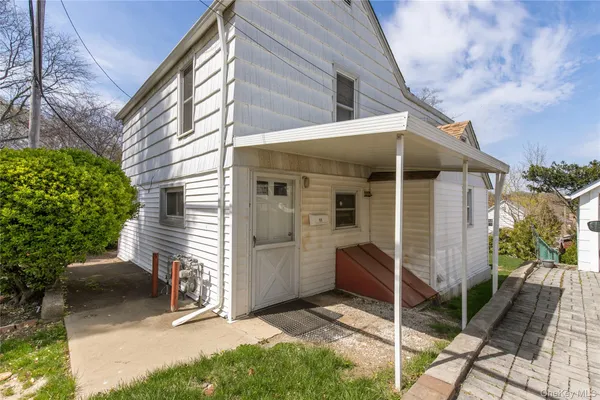 a view of house with a door and wooden fence