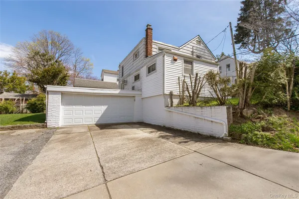 a view of a house with a yard and potted plants