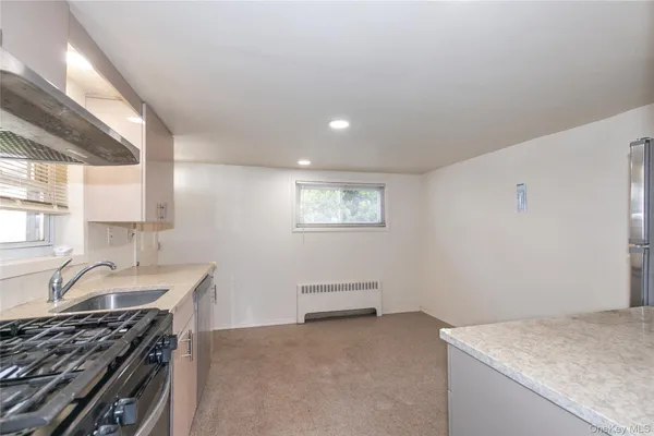 a kitchen that has a sink and a stove