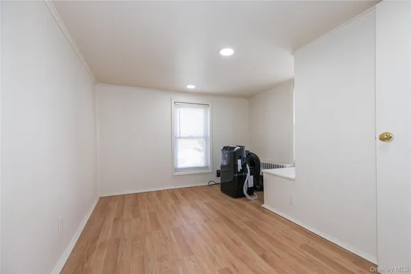 a view of a room with wooden floor and furniture