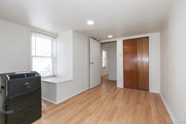 a view of a livingroom with wooden floor and windows