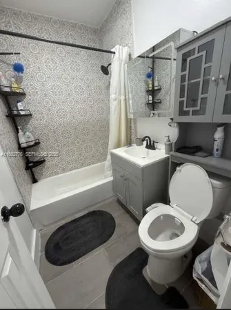 a bathroom with a toilet a sink and bathtub